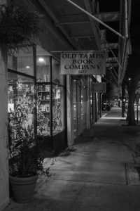 A black-and-white image of the haunted Old Tampa Book Company, a now-defunct book store in downtown Tampa rumored to be plagued by a mysterious top hat-wearing ghost. 